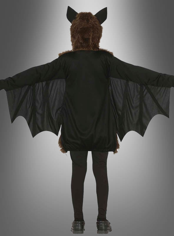 Eine Person, die das Plüsch-Fledermaus-Kostüm für Kinder trägt – mit ausgebreiteten Flügeln, einer pelzigen Kopfbedeckung mit Ohren und schwarzen Leggings –, ist von hinten vor einem grauen Farbverlaufshintergrund zu sehen – damit ist es die ideale Wahl für ein Halloween-Kostüm für Kinder.