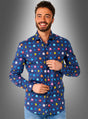 Ein Mann steht vor einem grauen Hintergrund mit Farbverlauf und lächelt in die Kamera. Er trägt ein blaues „Pac-Man-Hemd“ von OppoSuits mit einem farbenfrohen Pac-Man-Muster – perfekt für eine 80er-Jahre-Mottoparty.