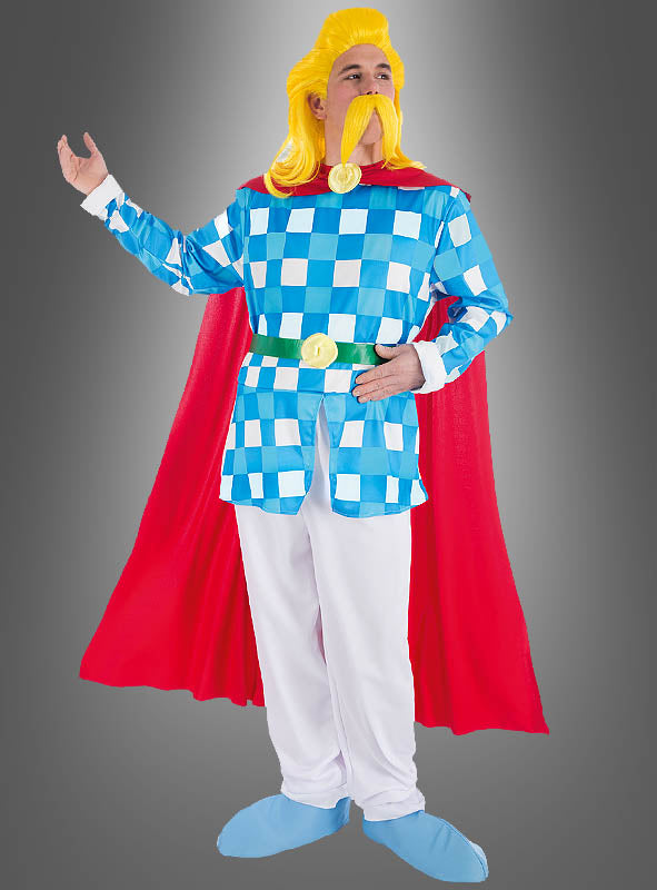 Eine Person im „Deluxe Troubadix“-Kostüm aus der Asterix-Reihe – bestehend aus einem blau-weiß karierten Outfit, einem roten Umhang, einer gelben Perücke, einem großen Schnurrbart, einer weißen Hose und blauen Schuhen – steht mit einem erhobenen Arm vor einem grauen Hintergrund. Perfekt für Fans, die ein authentisches Kostüm aus der Asterix-Kollektion suchen.