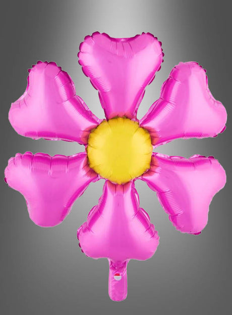 Der Folienballon „Blume“ (55 x 70 cm), der in verschiedenen Farben erhältlich ist, wird hier in einem Design mit einer rosa Blume mit sechs herzförmigen Blütenblättern und einer gelben Mitte gezeigt – ideal als Dekoration für eine Hippie-Party oder eine Gartenparty – vor einem grauen Hintergrund mit Farbverlauf.