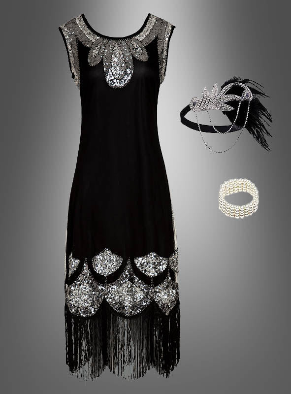 XXL-Kostüm im Stil der 20er Jahre mit Accessoires „Tatiana“: Elegantes schwarzes Charleston-Kleid im Stil der 1920er Jahre mit silbernen Pailletten, Fransenbesatz und passenden Accessoires wie Stirnband, Armband und Feder-Haarschmuck auf grauem Hintergrund – perfekt als Paillettenkleid in Übergröße für stilvolle Flapper-Looks.