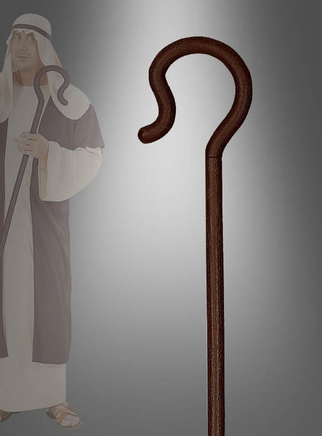 Im Mittelpunkt steht ein weißer oder brauner Hirtenstab, während im Hintergrund eine Person in traditioneller Schäfertracht und mit Kopfbedeckung einen passenden Stab in der Hand hält – ideal für Krippenspiele und festliche Nachstellungen.