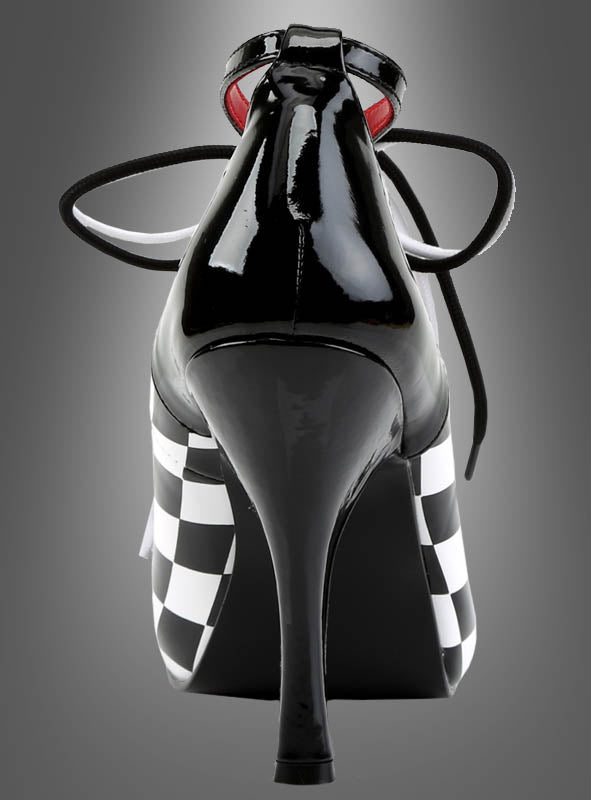Harlekin Schachbrett Schuhe Clown – schwarze Schuhe mit hohen Absätzen und glänzender Oberfläche, mit schwarz-weißen Schachbrettmuster-Seiten und schwarzen Schnürsenkeln, von hinten vor einem grauen Farbverlaufshintergrund präsentiert; ein auffälliges Statement-Stück, inspiriert von klassischen Harlekin-Schuhen.