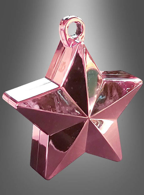 Ein glänzendes, metallisch-rosa Ballongewicht „Stern“ (150 g) – sternförmig mit einer Schlaufe an der Oberseite – vor einem grau verlaufenden Hintergrund, perfekt, um jeder Ballondekoration einen Hauch von Flair zu verleihen.