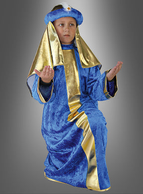 Ein Kind präsentiert das „Weiser aus dem Morgenland – blau“-Kinderkostüm, bestehend aus einem blau-goldenen Gewand mit passender Kopfbedeckung, und posiert mit erhobenen Händen für ein Krippenspiel.