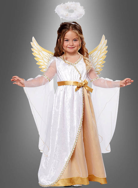 Ein kleines Mädchen, gekleidet in ein Schutzengel-Kostüm für Kleinkinder mit goldenen Flügeln, einem weiß-goldenen Kleid und einem weißen Heiligenschein-Stirnband, steht mit leicht ausgestreckten Armen vor einem grauen Hintergrund – ein bezaubernder Weihnachtskostüm-Look für Mädchen, ideal für die festliche Jahreszeit.