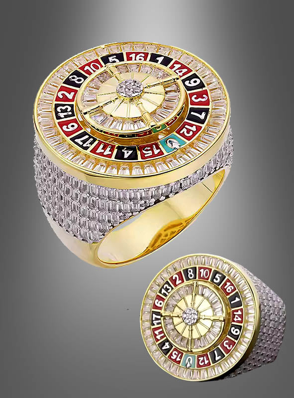 Ein Roulette-Rad aus 14-karätigem Gold von Edler Casino, das ein Roulette-Rad-Design mit farbigen Zahlen auf der Oberseite zeigt und aus zwei verschiedenen Blickwinkeln vor einem grauen Hintergrund dargestellt ist.