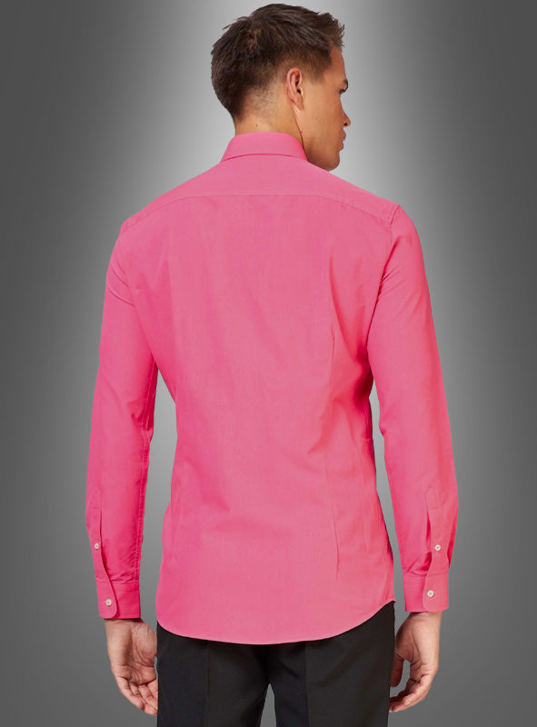 Ein Mann steht mit dem Rücken zur Kamera und trägt ein langärmeliges Herrenhemd in Pink mit figurbetontem Schnitt sowie eine schwarze Hose vor einem grauen Hintergrund mit Farbverlauf.