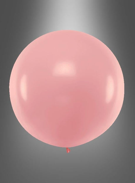 Ein einzelner rosa XXL-Ballon der Marke „Runde Riesen“ (60–100 cm) schwebt vor einem grauen Hintergrund mit Farbverlauf.