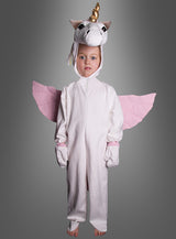 Ein Kind trägt das „Zauberhaftes Plüsch-Einhorn-Kostüm Deluxe“ mit weißem Oberteil, rosa Flügeln und einem Einhorn-Kopfschmuck und steht vor einem grauen Hintergrund – die perfekte Wahl unter den Tierkostümen für Mädchen zu Fasching, Karneval oder Halloween.