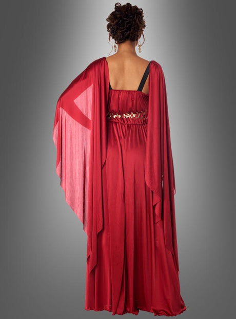 Eine Person, von hinten gesehen, die das „Griechische Göttin der Morgenröte Eos“ trägt – ein langes, rotes, drapiertes Kleid, das von einem Kleid einer griechischen Göttin inspiriert und mit einem Ziergürtel verziert ist –, vor einem schlichten grauen Hintergrund.