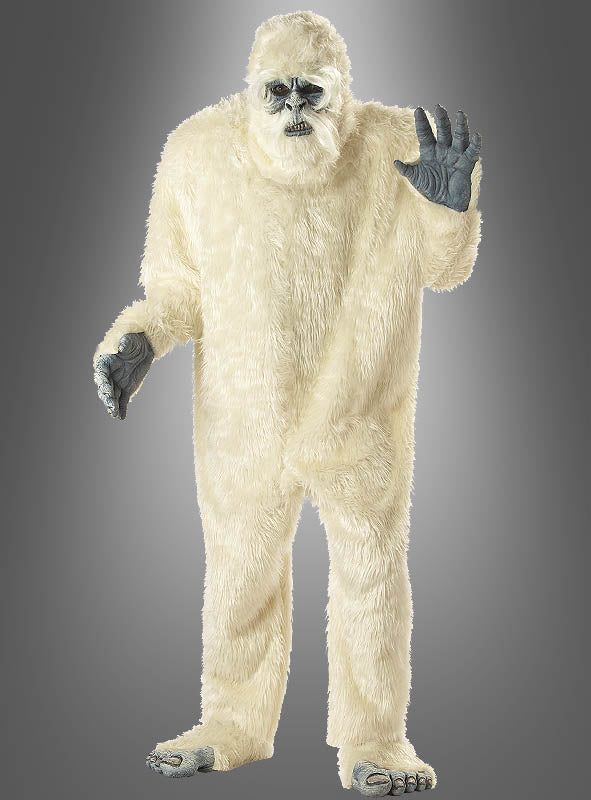 Eine Person steht aufrecht vor einem grauen Hintergrund mit Farbverlauf und trägt das Yeti-Kostüm für Erwachsene – ein weißes, pelziges Kostüm mit grauen Händen, Füßen und Gesicht –, während sie eine Hand hebt.