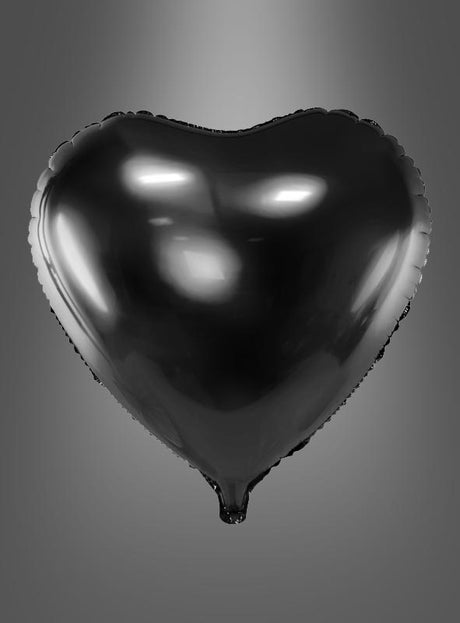Der Herz-Folienballon – ein Geschenk für viele Anlässe in glänzendem Schwarz – schwebt vor einem schlichten grauen Hintergrund, während Lichtreflexe auf seiner Oberfläche glitzern.