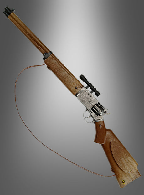 Das „Texas Ranger Gewehr für Cowboys“ verfügt über einen braunen Holzschaft, einen silbernen Verschluss mit gravierten Details, ein montiertes Zielfernrohr und einen Lederriemen und verkörpert damit den klassischen Stil, der ideal zu jedem Cowboy-Kostüm passt. Dargestellt vor einem grauen Hintergrund mit Farbverlauf.