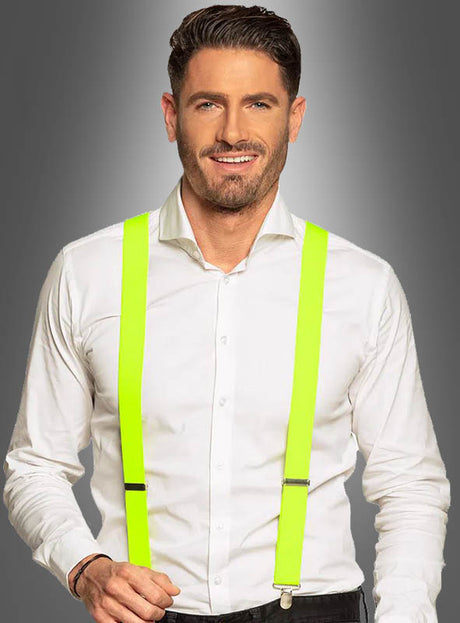 Ein Mann trägt ein weißes Hemd, kombiniert mit stylischen Neon-Hosenträgern in tollen Farben – perfekt für eine 80er- und 90er-Jahre-Party – und steht vor einem grauen Hintergrund mit Farbverlauf. Dieser stilvolle Look mit diesen Hosenträgern für Damen und Herren verleiht jedem Anlass einen verspielten Retro-Touch.