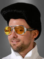 Ein Mann mit einer schwarzen Perücke im Elvis-Presley-Stil, der „King of Rock Elvis Brille 60er“ – einer gelb getönten Retro-Pilotenbrille – und einem weißen Outfit mit hohem Kragen posierte vor einem grauen Hintergrund.