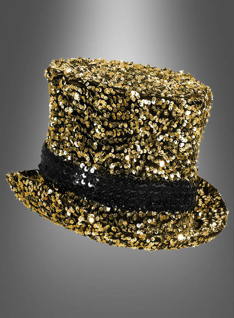 Ein „Pailletten-Zylinder Deluxe“ in Gold, der mit goldenen Pailletten überzogen ist und ein breites schwarzes Paillettenband aufweist, wird vor einem schlichten grauen Hintergrund mit Farbverlauf präsentiert.