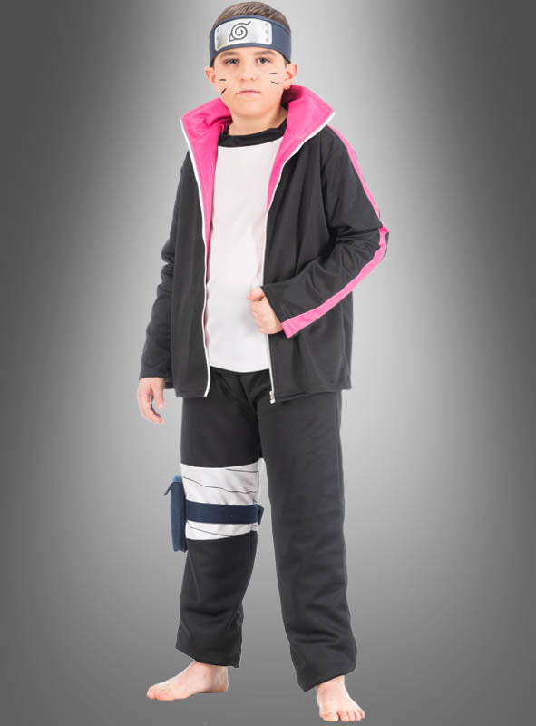 Ein kleiner Junge trägt das „Boruto Manga Kinderkostüm aus Naruto“, bestehend aus einer schwarzen Jacke mit rosa Futter, einem Stirnband mit Metallemblem und einer Beintasche, und steht vor einem grauen Hintergrund.