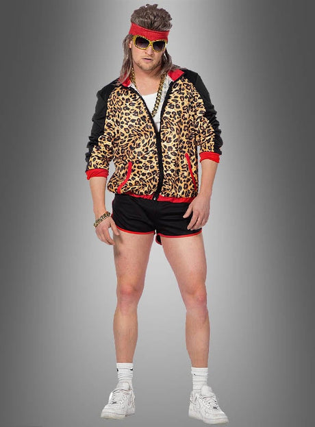 Eine Person, die eine Leopardenjacke im 80er-Jahre-Stil trägt, dazu kurze Hosen, ein rotes Stirnband, eine goldene Sonnenbrille, weiße Socken und weiße Sneaker, vor einem grauen Hintergrund stehend – ein ikonischer 80er-Jahre-Kostüm-Look.