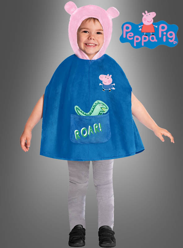 Ein Kind im „George Peppa Wutz“-Kostüm für Jungen, bestehend aus einem blauen Umhang mit einer rosa Kapuze in Form von Schweineohren, einer grauen Hose und schwarzen Schuhen, steht lächelnd da; das „Peppa Pig“-Logo ist in der rechten oberen Ecke zu sehen.
