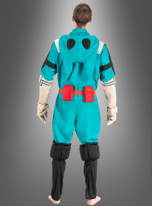 Eine Person, die ein Izuku-Midoriya-Kostüm für Erwachsene aus „My Hero Academia“ in den Farben Blaugrün und Schwarz mit roten Gürteltaschen trägt, von hinten gezeigt und barfuß vor einem grauen Hintergrund mit Farbverlauf stehend.