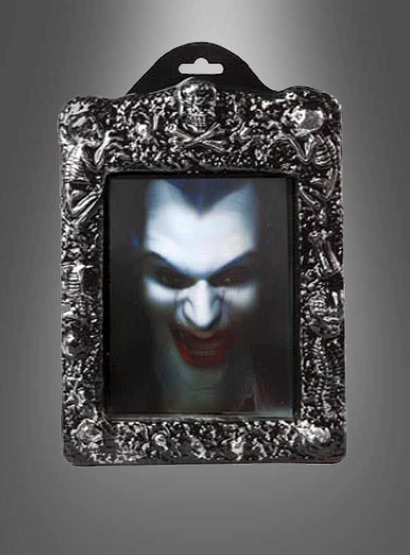 Ein dekorativer Rahmen mit einem Linsenbild, das ein unheimliches Vampirgesicht zeigt – mit blasser Haut, roten Lippen und scharfen Reißzähnen vor einem dunklen Hintergrund mit Farbverlauf. Dieses „Wackelbild Halloween-Hologramm“ erzeugt einen auffälligen 3D-Effekt, der jeder Umgebung eine unheimliche Note verleiht.