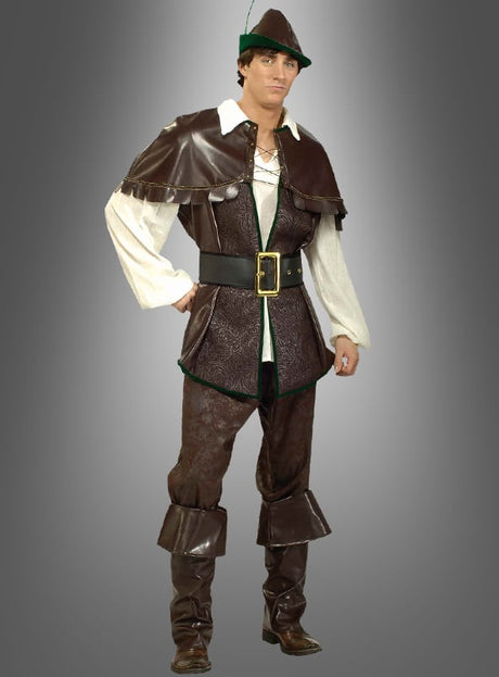 Eine Person trägt das Designer-Robin-Hood-Kostüm Deluxe: ein klassischer Look mit grünem Hut, brauner Weste, Gürtel, weißem Hemd, brauner Hose und Stiefeln – das perfekte Mittelalterkostüm für Fans von Karnevalskostümen. Die Figur steht vor einem grauen Hintergrund mit Farbverlauf.