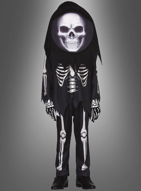 Vor einem neutralen Farbverlaufshintergrund ist ein Kind zu sehen, das das „Skelett-Kostüm mit Totenkopf für Kinder“ trägt, ergänzt durch eine große Totenkopfmaske, schwarze Handschuhe und schwarze Schuhe.