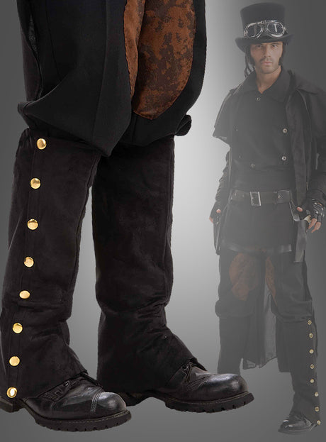 Ein Mann in einem Steampunk-Outfit trägt schwarze Gamaschen „Piraten & Steampunk“ mit goldenen Knöpfen über seinen Stiefeln, dazu eine schwarze Hose, einen langen Mantel und einen Zylinder, der mit einer Schutzbrille verziert ist, vor einem grauen Hintergrund – das perfekte Kostümzubehör für alle, die ihrem Look das authentische Flair von Gamaschen verleihen möchten.