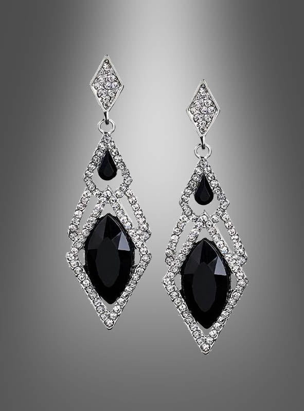 Elegante Silberohrringe für Damen mit großen schwarzen Edelsteinen und kleinen klaren Kristallen in geometrischen Mustern, präsentiert vor einem grauen Hintergrund mit Farbverlauf.