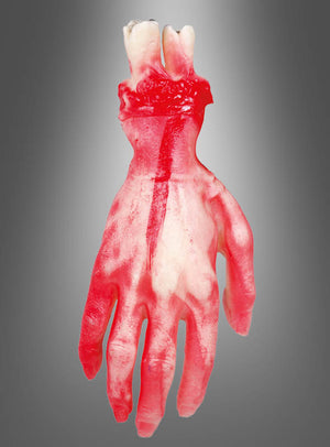 Die Halloween-Dekoration „Abgetrennte Hand“ ist ein realistisch aussehendes Gummibonbon in Form einer abgetrennten Hand in den Farben Rot und Weiß – perfekt als gruselige Halloween-Dekoration für jede Horrorparty – vor einem grauen Hintergrund mit Farbverlauf.