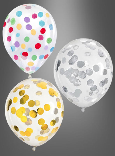 Drei transparente Konfetti-Ballons, gefüllt mit buntem, goldenem und silbernem Folienkonfetti, sind vor einem grauen Hintergrund mit Farbverlauf zu sehen.