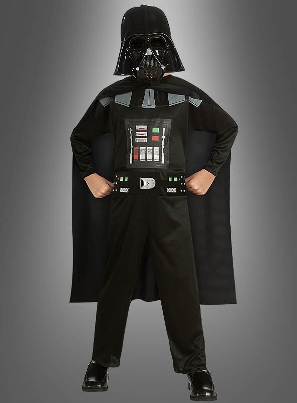 Ein Kind im Darth-Vader-Kinderkostüm steht selbstbewusst mit den Händen in den Hüften vor einem grauen Hintergrund und präsentiert stolz dieses kultige Star-Wars-Kostüm. Als offizielles Lizenzkostüm gibt es den legendären Look aus der Saga originalgetreu wieder.