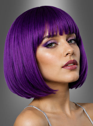 Eine Frau mit kurzen, glatten, violetten Haaren und Pony, die die schicke Bob-Perücke „Helene Blau Lila Grün“ trägt und deren Make-up durch violetten Lidschatten geprägt ist, blickt vor einem grau verlaufenden Hintergrund über ihre Schulter.