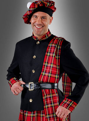 Ein Mann im Schottenkostüm „Mac Andrew“ – einer klassischen schottischen Tracht mit Tartan-Schärpe, schwarzer Jacke, passender Baskenmütze und Schottenrock –, die sich perfekt für den Karneval eignet, steht vor einem einfarbigen grauen Hintergrund.
