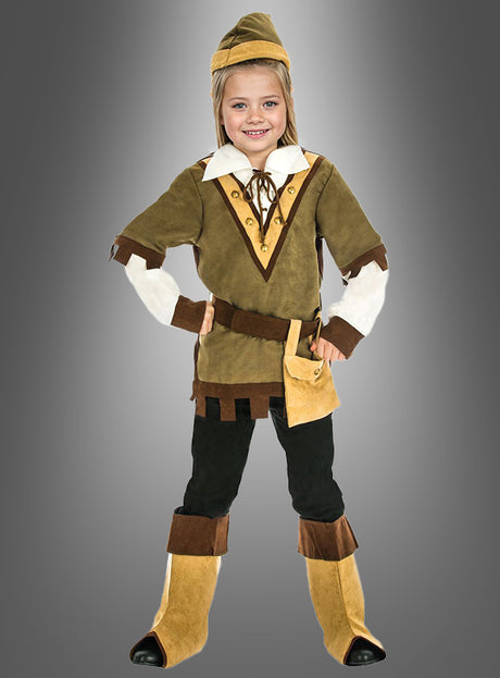 Vor einem grauen Hintergrund mit Farbverlauf steht ein Kind lächelnd, die Hände in die Hüften gestemmt, und trägt ein Robin-Hood-Kinderkostüm mit spitzem Hut, Tunika, Gürtel, Beutel, Hose und Stulpen.