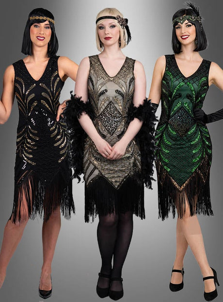 Drei Frauen stehen Seite an Seite in stilvollen, glamourösen Flapper-Kleidern namens „Vivian“; sie tragen ikonische Fransenkleider und Stirnbänder, die von der Mode der 20er Jahre inspiriert sind, und posieren elegant vor einem grauen Hintergrund mit Farbverlauf.