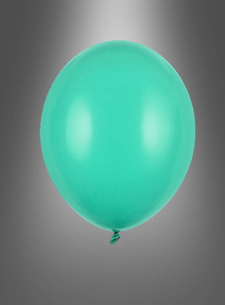 Ein einzelner aufgeblasener, hochwertiger Latex-Luftballon in Grün schwebt vor einem neutralen grauen Hintergrund, über dem ein dezenter Scheinwerfer-Effekt zu sehen ist.