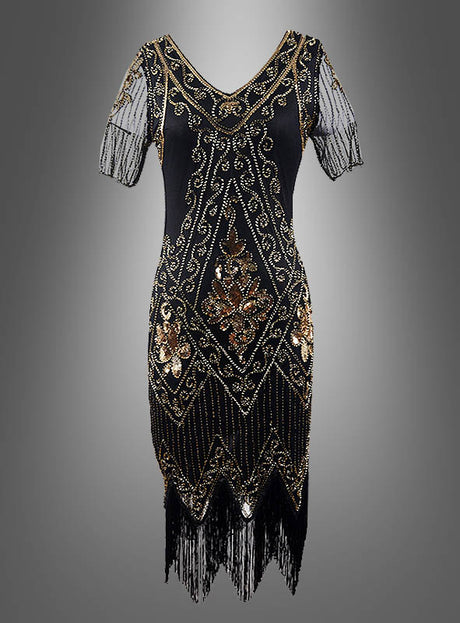 20er-Jahre-Paillettenkleid „Gitta“ in Schwarz mit transparenten Ärmeln, verziert mit goldenen und bronzefarbenen, perlenbesetzten geometrischen und floralen Mustern, transparenten Kurzarm-Ärmeln mit Perlendetails sowie einem Fransensaum – stilvoll präsentiert auf grauem Hintergrund und ideal als glamouröses 20er-Jahre-Kleid oder auffälliges Paillettenkleid für Damen für deine nächste 20er-Jahre-Party.