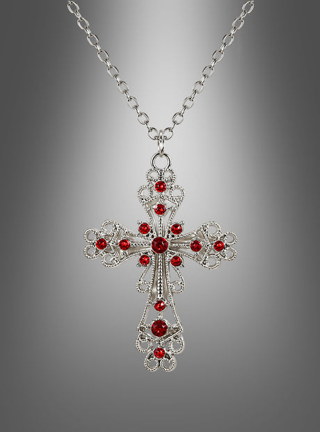 Eine Halskette mit dem Anhänger „Kreuz Kette mit roten Steinen“, die sich durch leuchtend rote Steine auszeichnet und vor einem sanften grauen Farbverlauf zur Geltung kommt, verkörpert die raffinierte Eleganz von Mittelalter Schmuck.