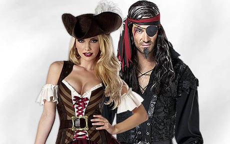 Eine Frau und ein Mann in Piratenkostümen posieren gemeinsam vor einem schlichten weißen Hintergrund.