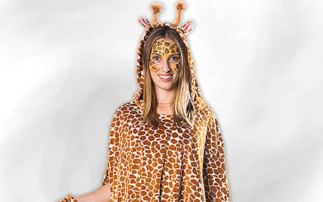 Eine Person in einem Giraffenkostüm mit Kapuze, Gesichtsbemalung und passendem gemustertem Outfit, die vor einem schlichten hellen Hintergrund steht.